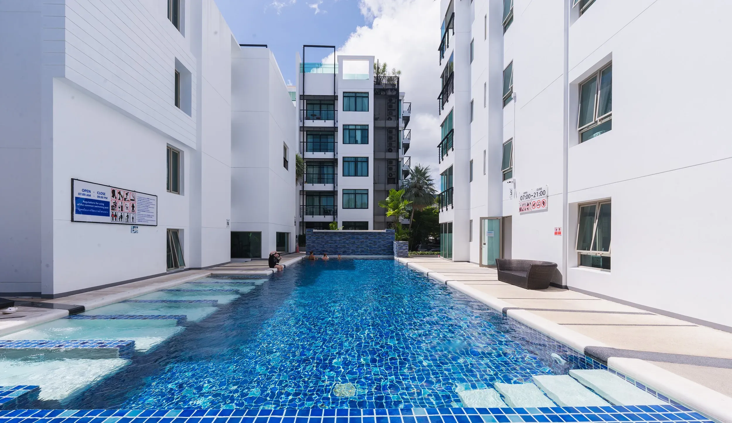 Stunning swimming pool situated between the two white low-rise buildings of The Regent Condo