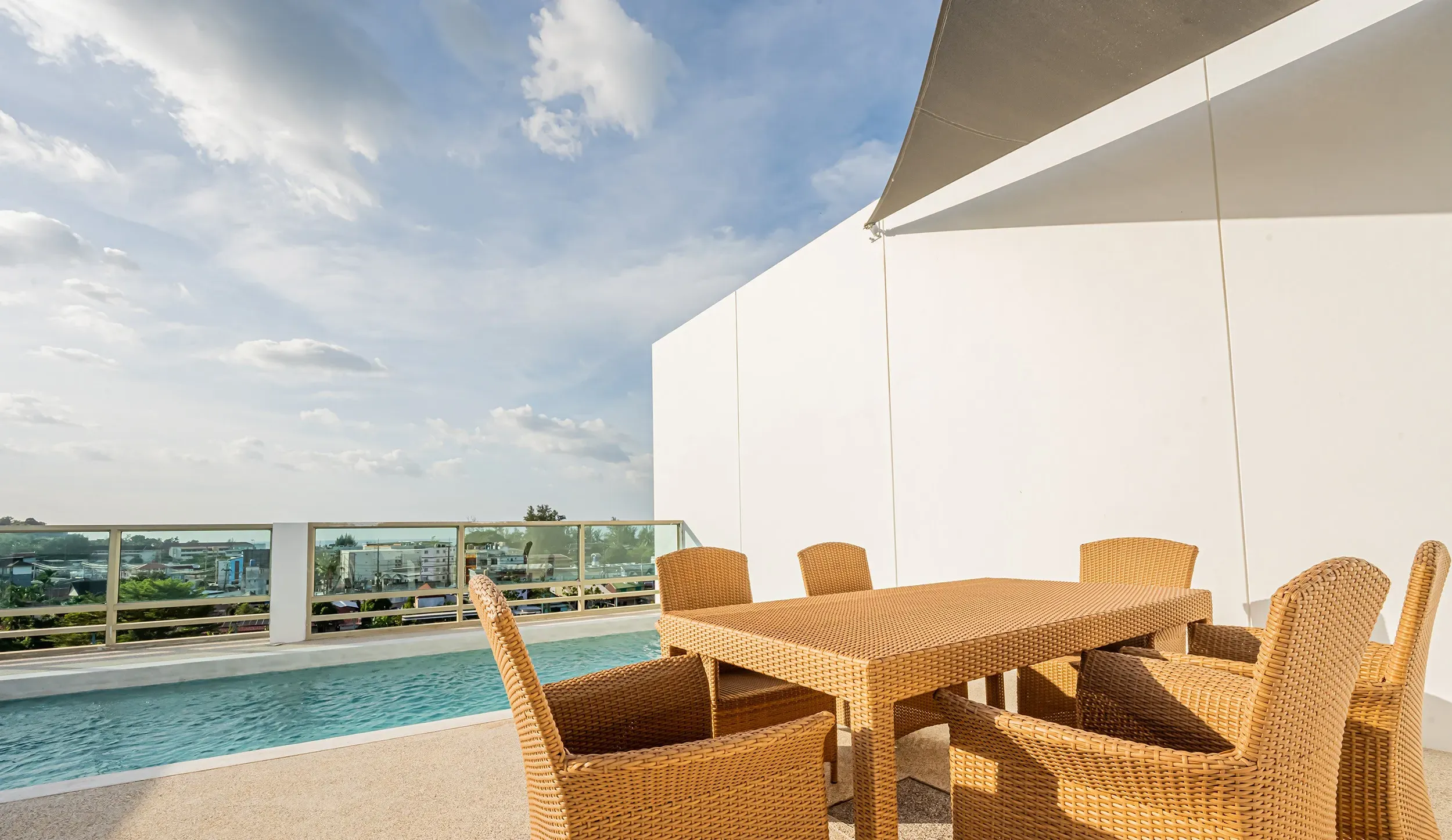 Beautiful terrace with an outdoor dining table situated right beside the pool
